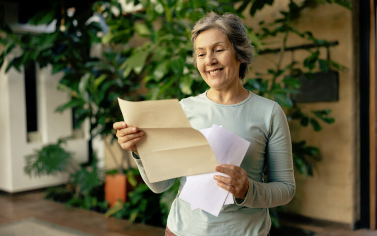 Bild einer Nierenpatientin, die sich über die schriftliche Bestätigung ihrer Aufnahme auf die Warteliste freut. Die Wartezeit berechnet sich ab dem Tag der ersten Dialyse.